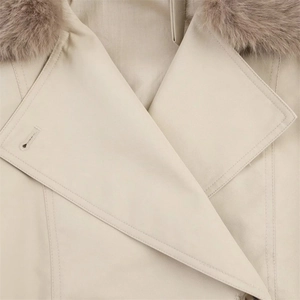 Close-up of beige waterproof jacket with fluffy faux fur collar and twill texture