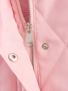 Macro shot of silver metal zipper and snap buttons on pink quilted corduroy jacket