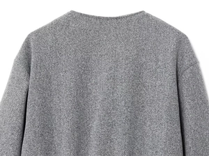 Close-up of grey bomber jacket neckline showing soft knit texture and shoulder stitching