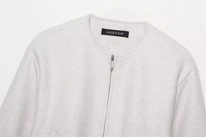 Close-up of Indefeir jacket collar showing soft gray wool fabric and silver zipper detail