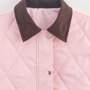 Pink diamond quilted jacket with brown corduroy collar and metallic button details