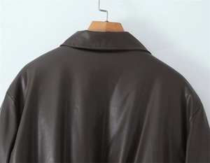 Detailed back view of vintage brown PU leather jacket with clean seam stitching