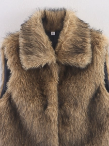 Close-up of brown faux fur vest texture showing high-quality fibers and inner size label