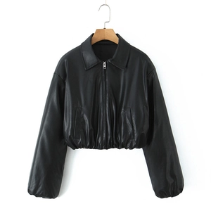 Detail view of the elastic pleated hem and cuffs on a black faux leather jacket