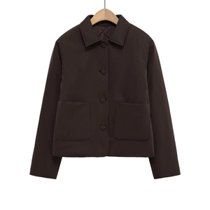 Detail of faux suede jacket featuring classic lapel, button closure and large front pockets