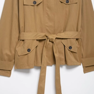 Short khaki belted trench jacket with utility pockets and contrasting buttons