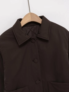 Detailed close-up of dark brown faux suede jacket featuring a classic collar and quilted lining