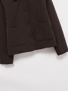Detail view of coffee faux suede jacket with large pockets and button closure