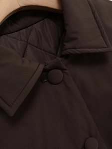 Detail view of the brown faux suede jacket featuring diamond quilted lining and buttons
