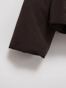 Detail of faux suede jacket showing matte texture and precise stitching on the sleeve