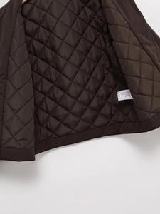 Detail of dark brown faux suede jacket lining with high-density diamond quilting