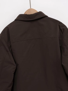 Detailed back view of a dark brown faux suede jacket with horizontal seam and turn-down collar
