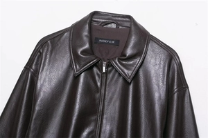 Detailed view of dark brown faux leather vintage jacket with collar and metal zipper