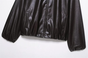 Detail view of deep brown faux leather flight jacket with ribbed hem and side pockets