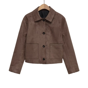 Detail shot of brown suede jacket showing lapel collar and large black round buttons