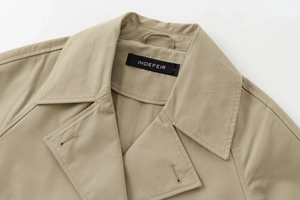 Detailed view of the double-breasted khaki jacket collar and twill fabric texture