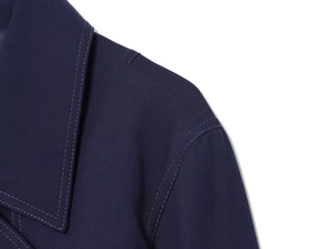 Detail of the navy blue twill fabric and reinforced double stitching on women's jacket