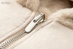 Detail of beige faux fur lining and premium suede stitching with silver metal zipper