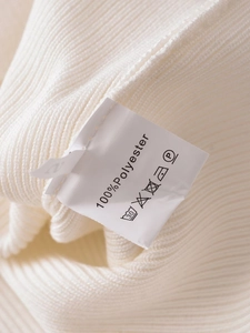 Close-up of white ribbed knit fabric with 100% polyester care label and size tag