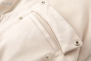 Detail of faux suede jacket featuring metal zipper and snap buttons on front pocket