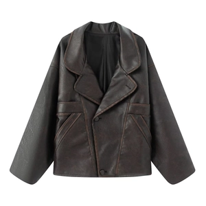 Detail of deep brown vintage PU leather jacket featuring retro lapels and textured finish