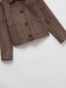 Detail of brown faux suede jacket featuring a classic lapel and black button closure