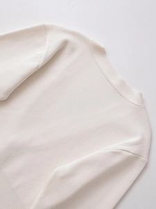 Detail of white V-neck knitted sweater neck seam and high-quality fine flat knit texture