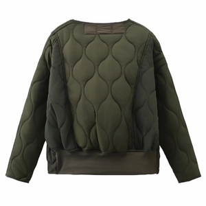 Detail of army green quilted jacket featuring onion-stitch pattern and ribbed hem