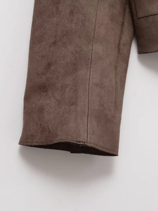 Macro shot of dark brown suede jacket cuff highlighting fine texture and premium stitching