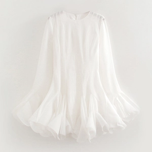 Detailed view of white long sleeve dress with layered ruffle hem and chiffon texture