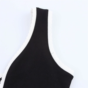 Close-up of contrast knit tank top with white scalloped wavy edge detailing and stitching