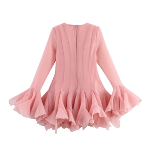 Detail of pink chiffon dress featuring tiered ruffled hem and dramatic flared cuffs