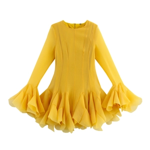 Detail of multi-layered ruffled hem and chiffon texture on a yellow long sleeve dress
