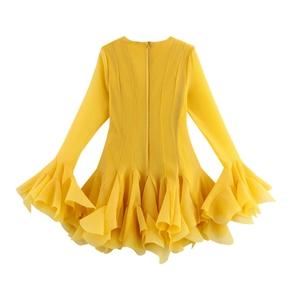 Close-up detail of tiered ruffled hem and textured lemon yellow chiffon fabric