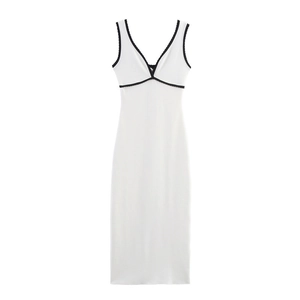 Detailed view of deep V-neck sleeveless white dress with black wavy contrast trim
