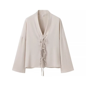 Beige loose long-sleeve tie-front shirt with textured fabric for a minimalist look