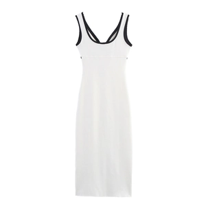 Detailed view of deep V-neckline with contrasting black trim on white bodycon dress