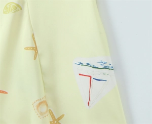 Detailed view of yellow fabric with lemon, starfish, and nautical hand-drawn patterns