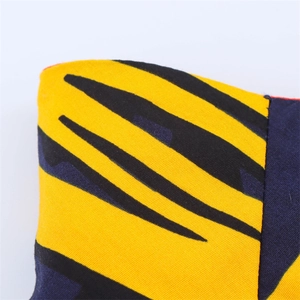 Detailed close-up of tiger stripe print fabric on a high-waisted yellow summer skirt