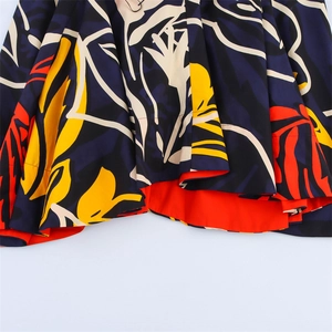 Detailed close-up of abstract floral print high waist skirt with orange lining