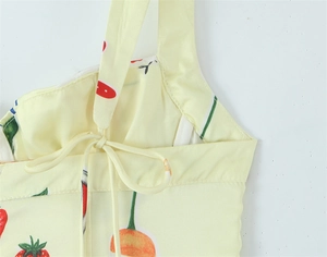 Detail of thin straps and adjustable back tie on a yellow floral print dress