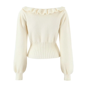 Detail of off-white knit sweater with ruffle boat neck and ribbed waist texture