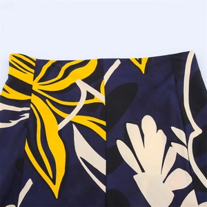 Elegant high waisted skirt featuring bold yellow and cream floral prints on navy blue fabric