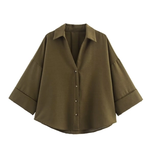 Close-up of olive green long blouse with wide cuffs and button-down collar details