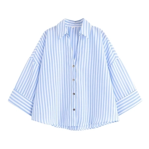 Close-up of blue and white striped shirt collar with size M tag and resin button detail