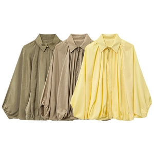 Detailed macro view of long-sleeve bomber jackets with pleated design and lantern sleeves
