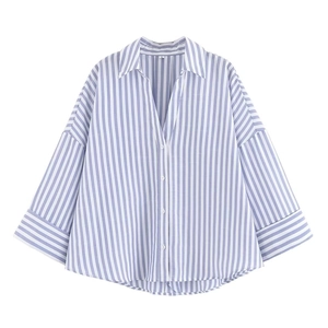 Detailed view of the pointed collar and size L label on blue vertical striped shirt