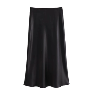 Detail of elegant black silk satin high waist midi skirt showing fabric sheen and drape