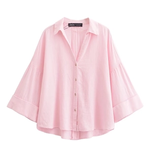 Close-up of pink casual loose shirt showing the collar, buttons and smooth fabric texture
