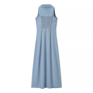 Detail view of the smocking back and A-line silhouette on light blue denim maxi dress